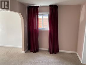 Toronto (Woodbine-Lumsden) apartment for rent - A room with a window and red curtains.