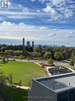 Toronto (Banbury-Don Mills) condo for rent - A real estate company's brokerage office overlooks a city skyline.