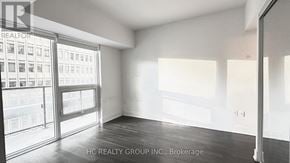 Toronto (Bay Street Corridor) condo for rent - A room with a view of a building through the windows.