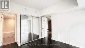 Toronto (Bay Street Corridor) condo for rent - A white room with a sliding glass door leading to a bathroom.