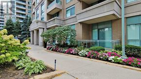 Toronto (Newtonbrook East) condo for rent - A building with a well-maintained garden in front.