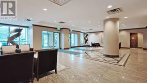 Toronto (Newtonbrook East) condo for rent - A spacious lobby with a large sculpture and a reception desk.