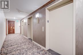 Toronto (Newtonbrook East) condo for rent - A hallway with a carpeted floor and doors on both sides.