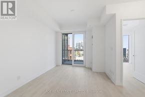 Hamilton (Corktown) condo for rent - A real estate listing image of a white room with a door leading to a balcony.