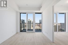 Hamilton (Corktown) condo for rent - A real estate listing image of a large empty room with a view of the city.