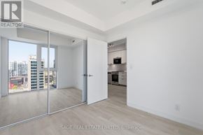 Hamilton (Corktown) condo for rent - A real estate listing image of a white room with a sliding glass door.
