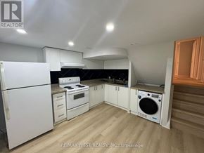 Toronto (Don Valley Village) apartment for rent - A kitchen with white appliances and wooden floors.