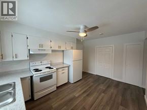 Lloydminster apartment for rent - A kitchen with white cabinets and a stove top oven.