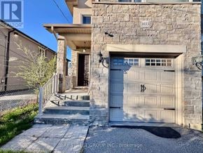 Mississauga (Lakeview) apartment for rent - A house with a stone wall and a grey garage door.