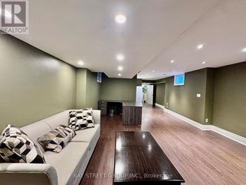 Mississauga (Lakeview) apartment for rent - A living room with a white couch and a wooden coffee table.