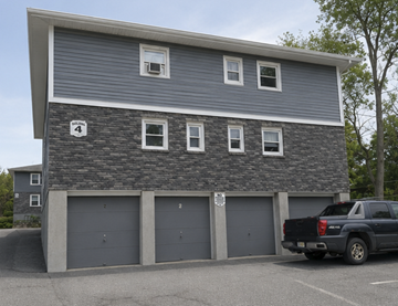 Cornwall apartment for rent - A grey building with a black truck parked in front.
