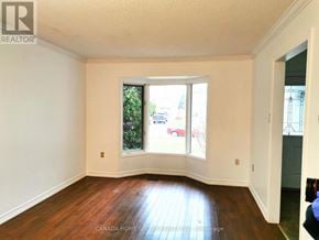 Barrie (Painswick North) apartment for rent - A room with a window and a wooden floor.