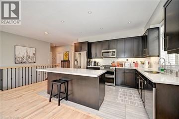 Kitchener apartment for rent - A living room with a white couch and a cowhide rug.