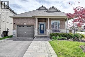 Kitchener apartment for rent - A house with a brick facade and a stone pillar is shown.