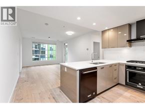 Vancouver apartment for rent - A modern kitchen with wooden floors and a large island.