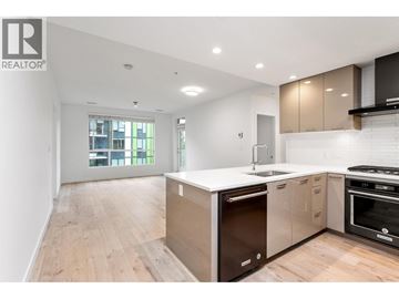 Vancouver apartment for rent - A modern kitchen with wooden floors and a large island.