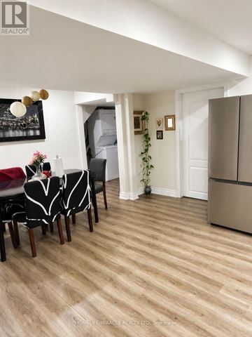 Brampton (Bram East) apartment for rent - A dining room with a table set for two and a kitchen area in the background.