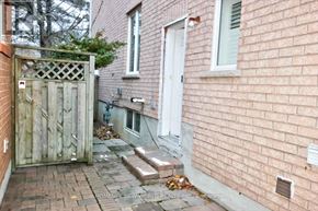 Toronto (Highland Creek) apartment for rent - A red brick house with a white door and a wooden gate.