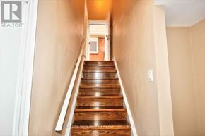 Toronto (Highland Creek) apartment for rent - A long hallway with a staircase leading to a door at the end.