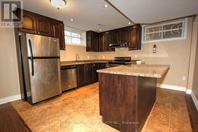 Toronto (Highland Creek) apartment for rent - A kitchen with a refrigerator, sink, and countertop.