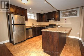 Toronto (Highland Creek) apartment for rent - A kitchen with a refrigerator, sink, and countertop.
