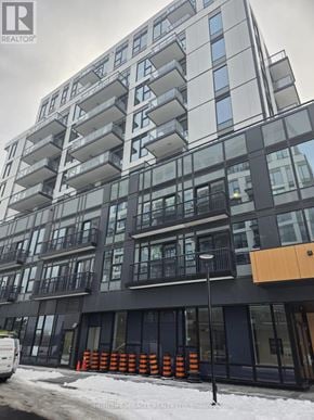 Toronto (Rouge) condo for rent - A modern apartment building with a white van parked in front.