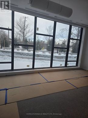 Toronto (Rouge) condo for rent - A room with large windows overlooking a snowy landscape.