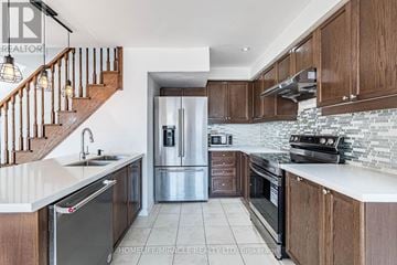 Brampton (Northwest Brampton) townhouse for rent - A kitchen with wooden cabinets and a stainless steel refrigerator.