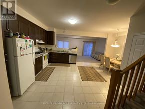 Kitchener apartment for rent - A kitchen with white appliances and brown cabinets.