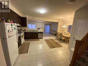 Kitchener apartment for rent - A kitchen with a white fridge and brown cabinets.