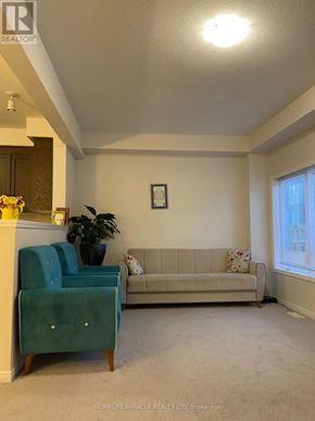 Kitchener apartment for rent - A living room with a blue chair and a couch.