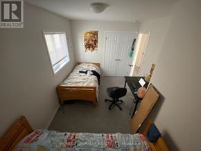Kitchener apartment for rent - A bedroom with a bed, desk, and chair.