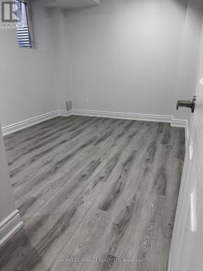 Halton Hills (Georgetown) apartment for rent - A room with wooden flooring and white walls.