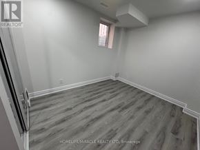 Halton Hills (Georgetown) apartment for rent - A room with wooden flooring and a window with blinds.