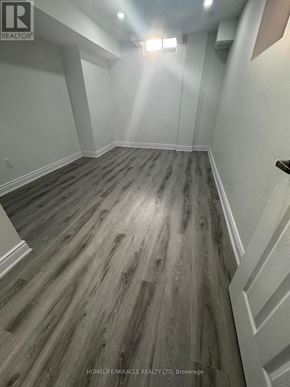 Halton Hills (Georgetown) apartment for rent - A hallway with wood flooring and white walls.