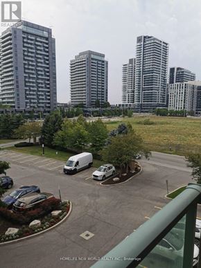 Richmond Hill (Langstaff) condo for rent - A parking lot with a white van and a white car.