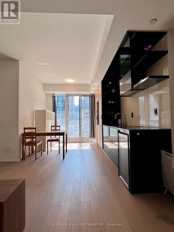 Toronto (Bay Street Corridor) condo for rent - A modern kitchen with a dining table and chairs is shown.