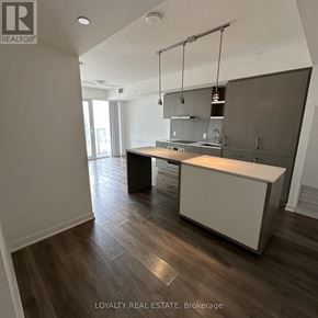 Toronto (Waterfront Communities) condo for rent - A kitchen with a large island in the middle of the room.