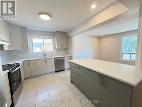 Ottawa multi-family for rent - A kitchen with white countertops and grey cabinets.
