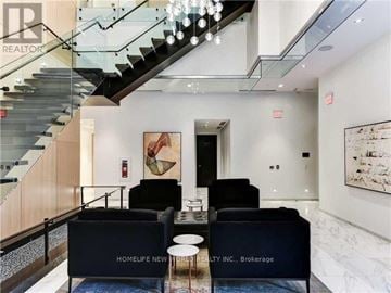 Toronto (Mount Pleasant West) condo for rent - A modern living room with a staircase and a couch that says "Homelife New".