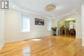 Richmond Hill (Rouge Woods) apartment for rent - A spacious room with wooden floors and a chandelier.