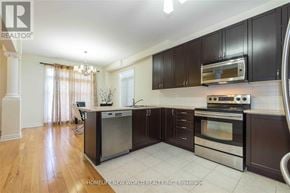 Richmond Hill (Rouge Woods) apartment for rent - A modern kitchen with dark brown cabinets and stainless steel appliances.
