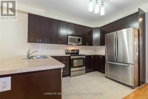 Richmond Hill (Rouge Woods) apartment for rent - A kitchen with a refrigerator, oven, and sink.