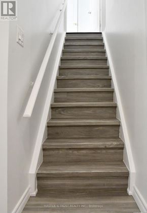 Markham (Cedar Grove) apartment for rent - A set of stairs with a white wall on the side and a white door at the top.