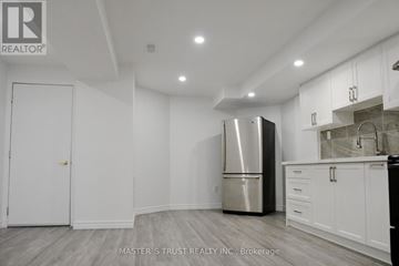 Markham (Cedar Grove) apartment for rent - A kitchen with a refrigerator, cabinets, and a counter.