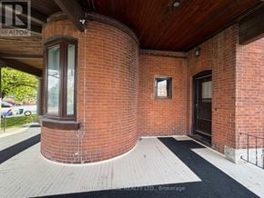 Belleville (Belleville Ward) fourplex for rent - A red brick building with a black door and a window.