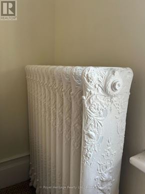Belleville (Belleville Ward) fourplex for rent - A white ornate radiator in a room.