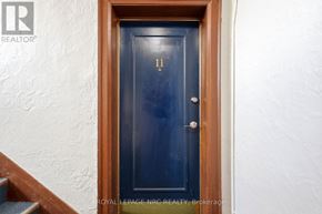 Hamilton (Stinson) condo for rent - A dark blue door with a silver handle and a number 11 above it.