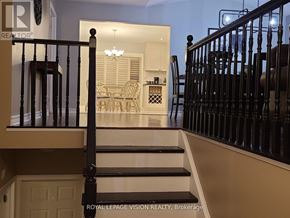 Niagara Falls (Ascot) apartment for rent - A staircase with a black railing and a white door at the bottom.