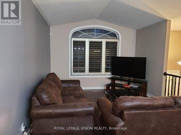 Niagara Falls (Ascot) apartment for rent - A living room with brown leather chairs and a flat screen TV.